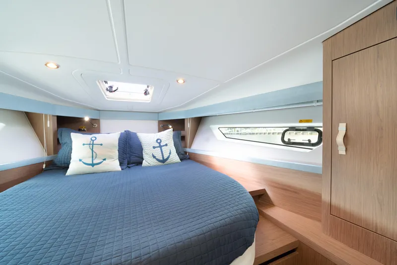 Slide: The Image of Luxurious cabin interior of 2017 Beneteau Gran Turismo 40 yacht with nautical-themed bedding. - 12