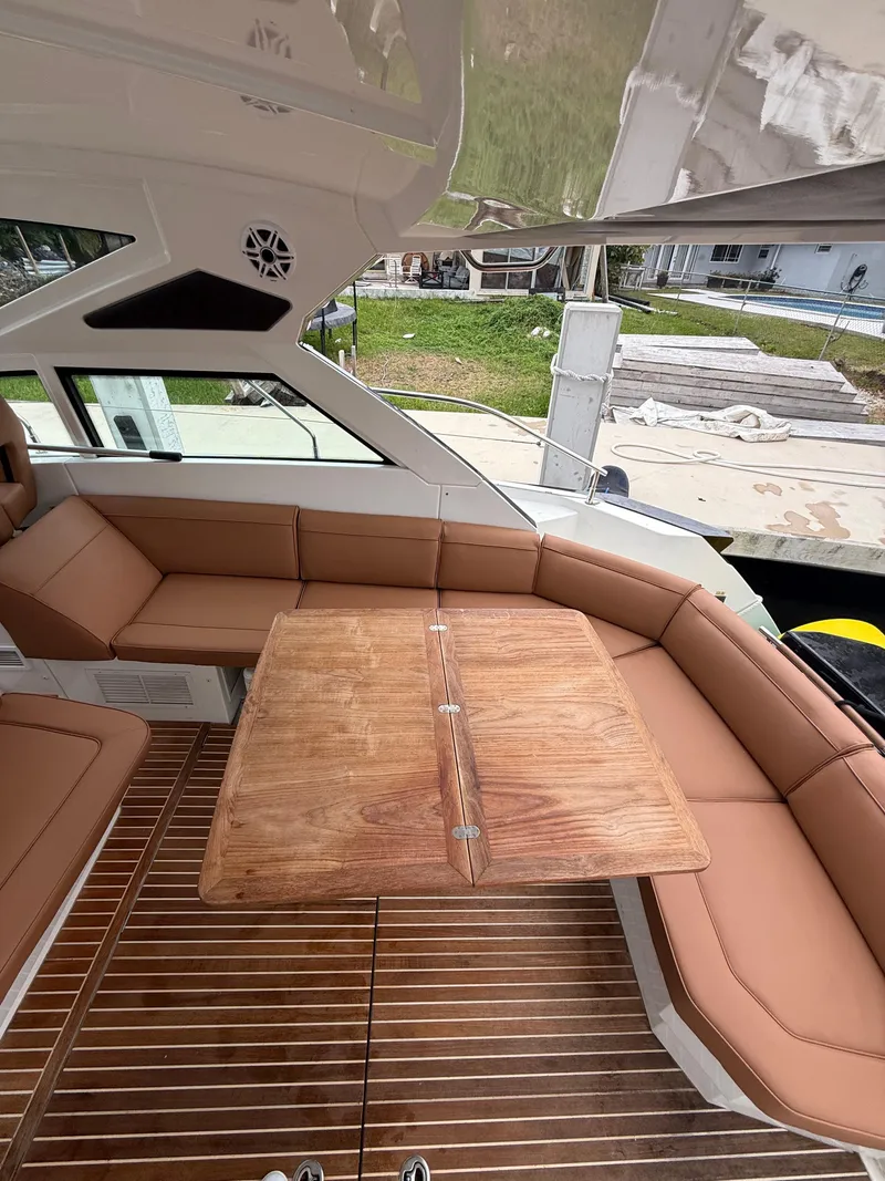Slide: The Image of Luxurious 2017 Beneteau Gran Turismo 40 yacht interior with elegant seating and wooden table. - 2