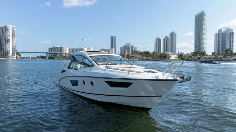 Slide: The Image of 2017 Beneteau Gran Turismo 40 yacht on water with city skyline backdrop. - 22