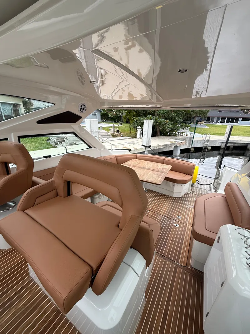 Slide: The Image of 2017 Beneteau Gran Turismo 40 yacht interior with brown leather seating and wood flooring. - 3