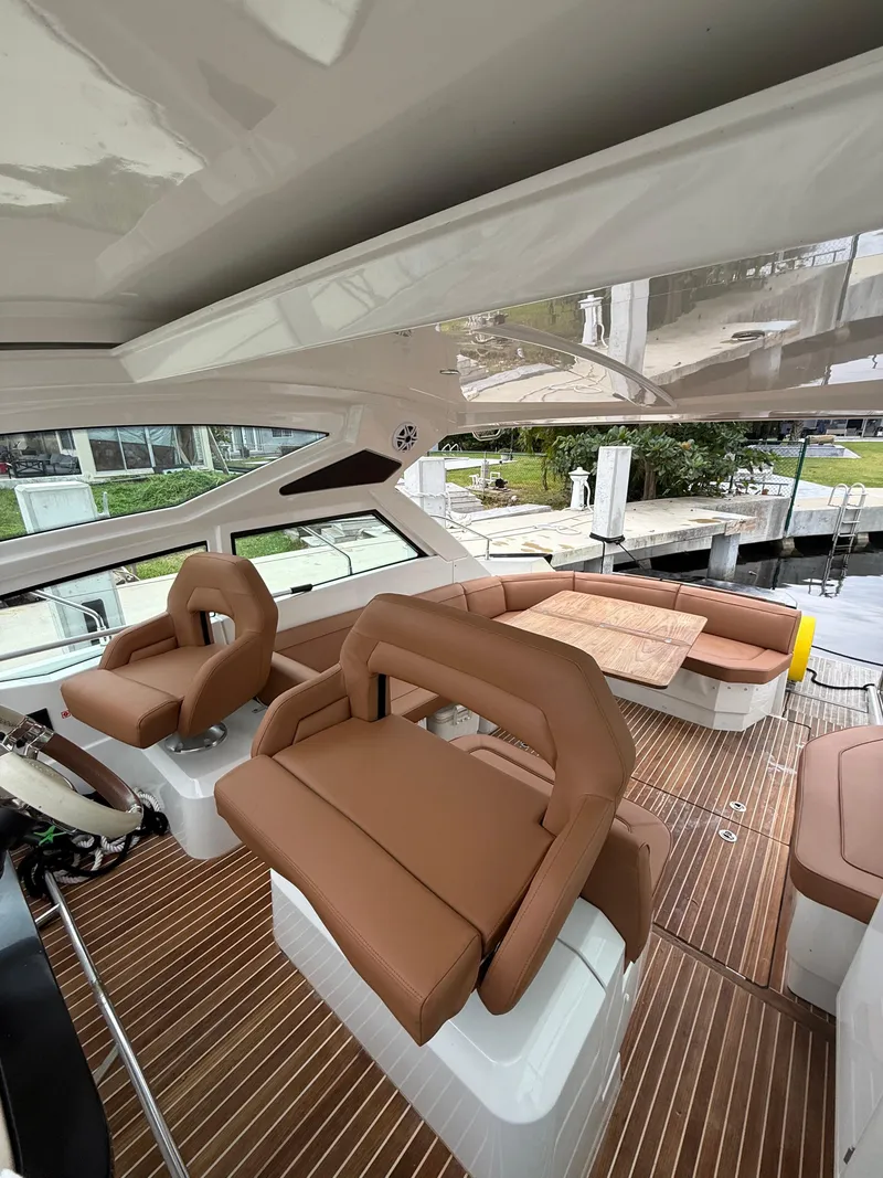 Slide: The Image of 2017 Beneteau Gran Turismo 40 yacht interior with brown seating and wood flooring. - 4