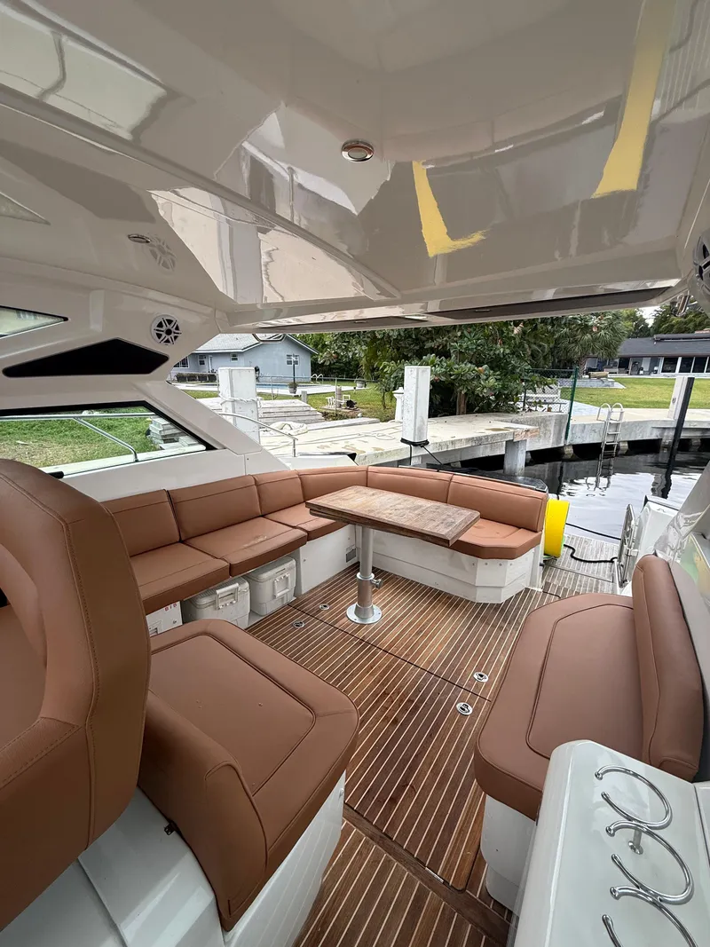 Slide: The Image of 2017 Beneteau Gran Turismo 40 yacht interior with brown seating and wood flooring. - 5
