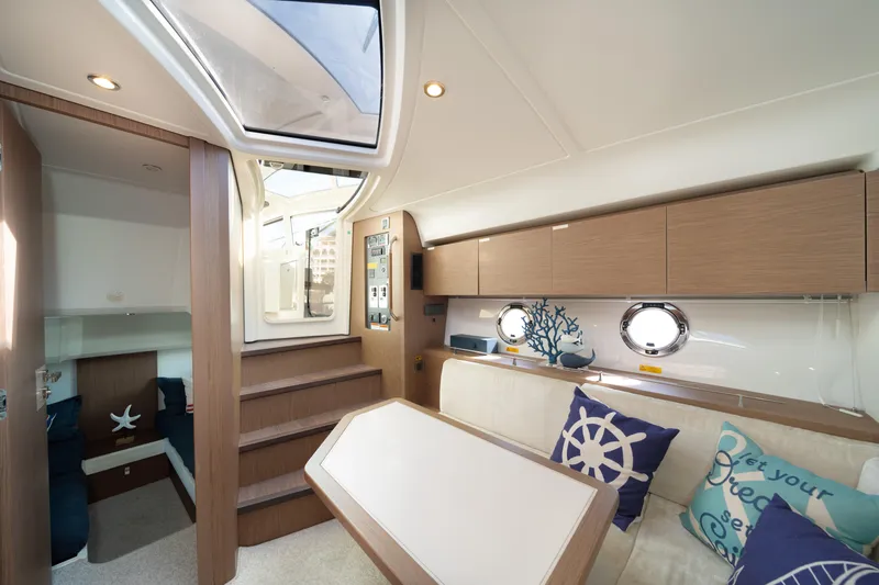 Slide: The Image of Interior of 2017 Beneteau Gran Turismo 40 yacht, featuring modern seating and nautical decor. - 9