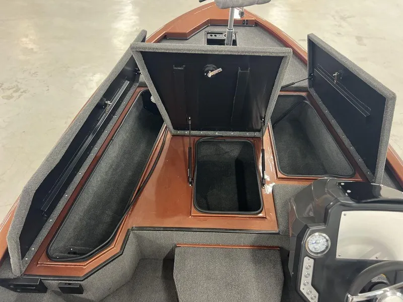 Slide: The Image of 2023 Avid 18XB boat interior with open storage compartments and steering console. - 11