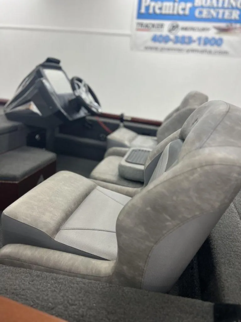 Slide: The Image of Interior of 2023 Avid 18XB boat with gray seating and steering console. - 19