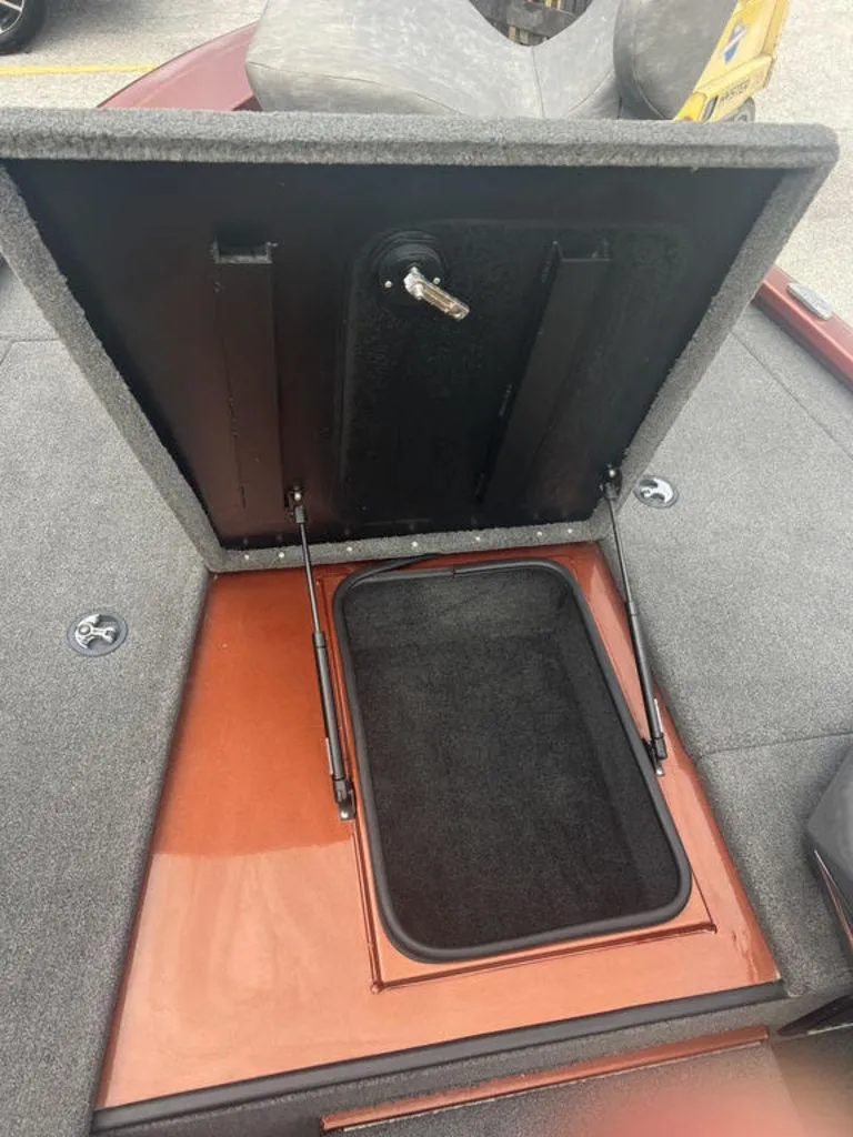 Slide: The Image of Open storage compartment in 2023 Avid 18XB boat, featuring hydraulic lift supports. - 20