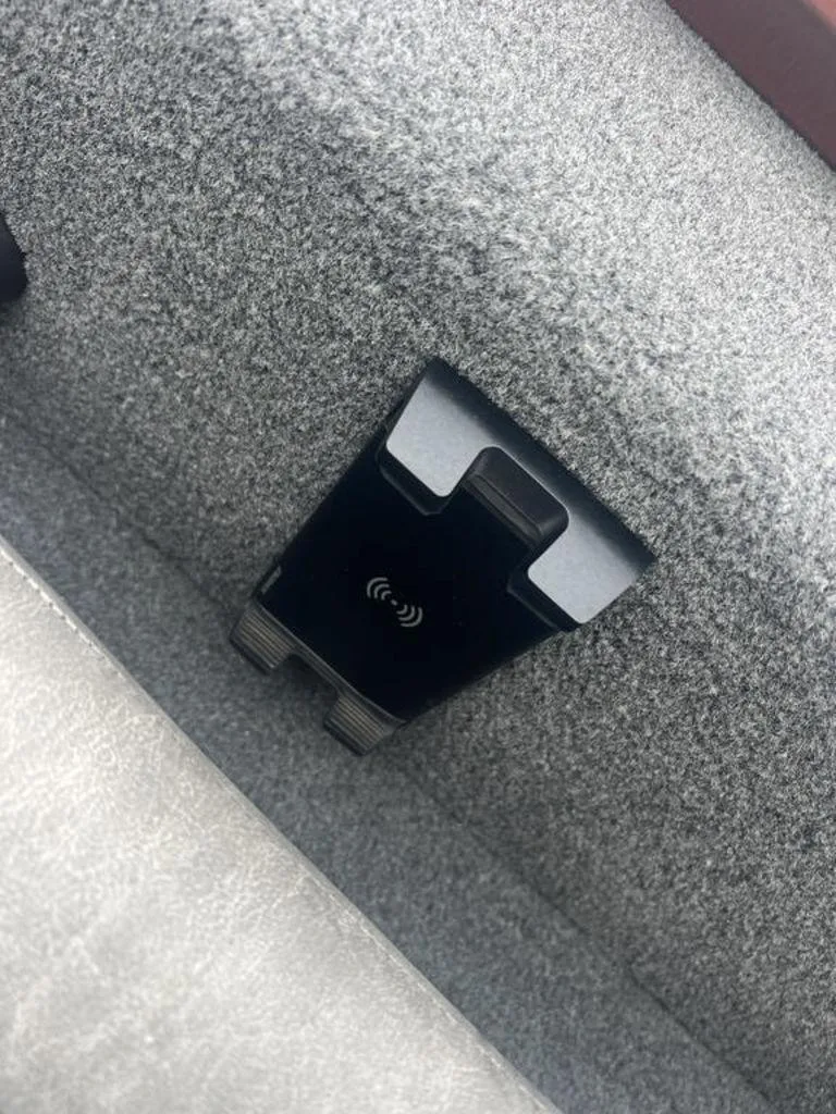 Slide: The Image of Avid 18XB 2023 wireless charging pad in a carpeted interior. - 21