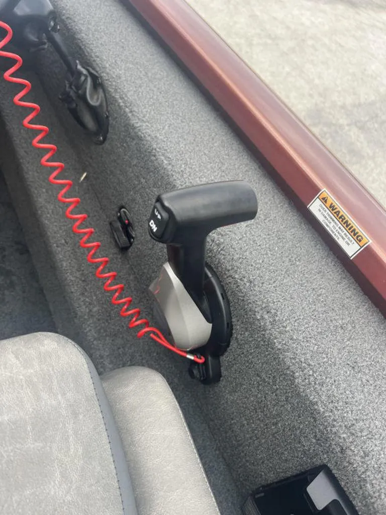 Slide: The Image of Avid 18XB 2023 boat throttle control with safety lanyard and warning label. - 22