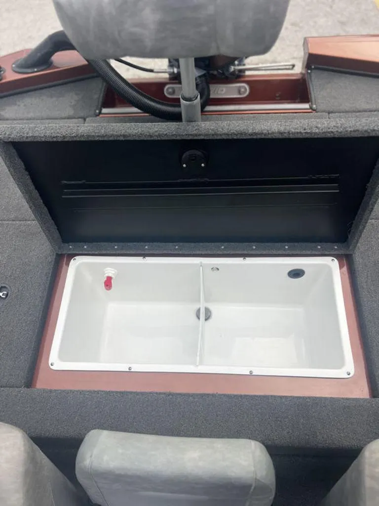 Slide: The Image of Avid 18XB 2023 boat interior with open storage compartment. - 24