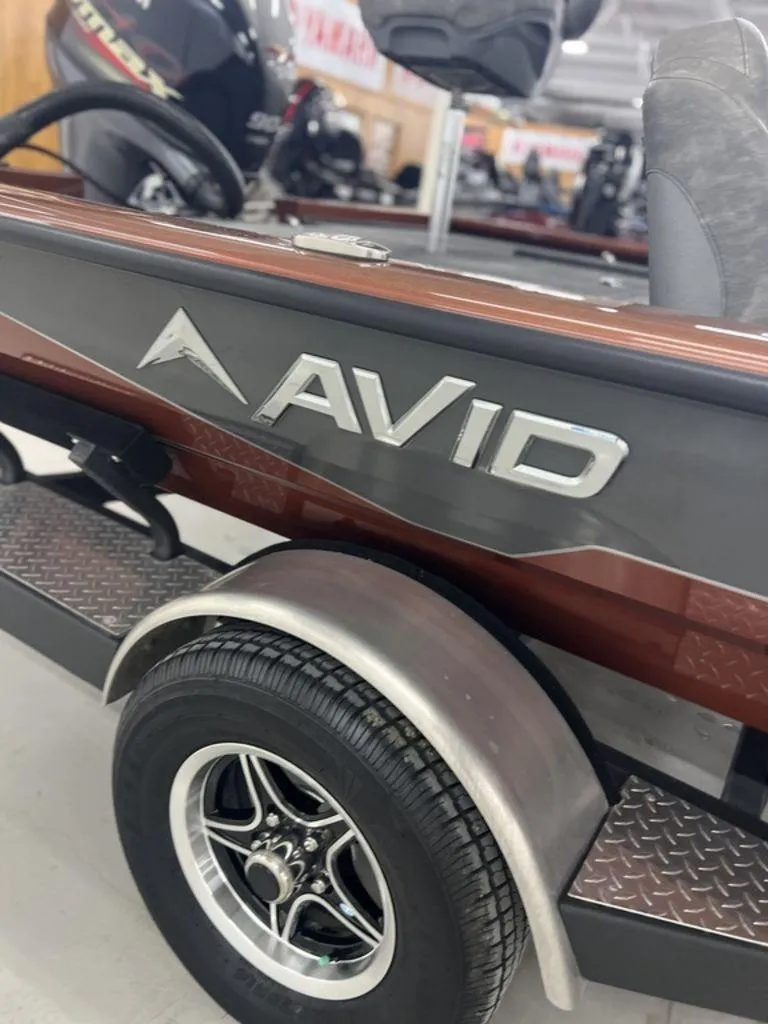 Slide: The Image of 2023 Avid 18XB boat on trailer, close-up of logo and wheel. - 31