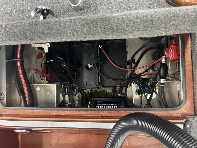 Slide: The Image of Avid 18XB 2023 boat battery compartment with wiring and components. - 32