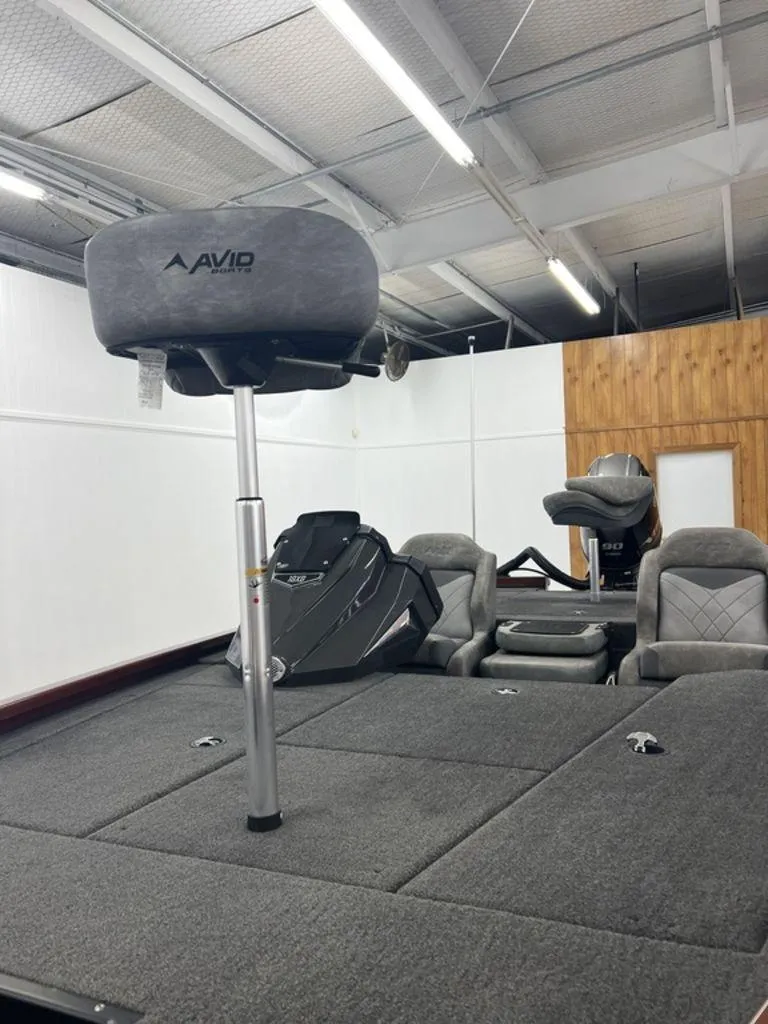 Slide: The Image of 2023 Avid 18XB boat interior with gray seating and carpeted deck. - 35