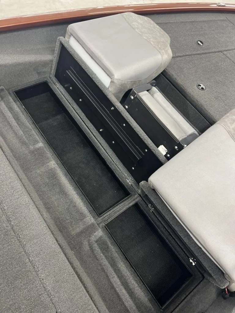 Slide: The Image of 2023 Avid 18XB boat interior with storage compartments and cushioned seating. - 36