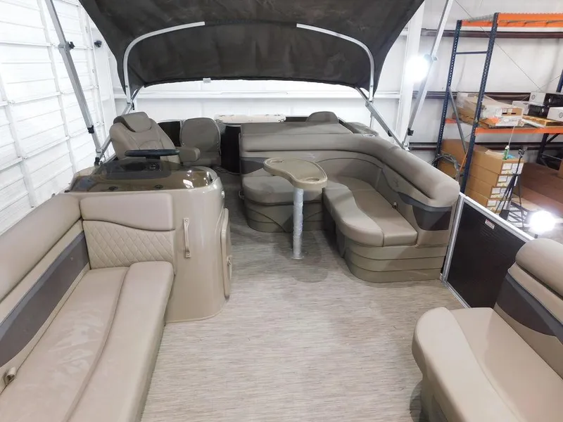 Slide: The Image of 2023 Bennington 20SSSP pontoon boat interior with beige seating and canopy. - 10