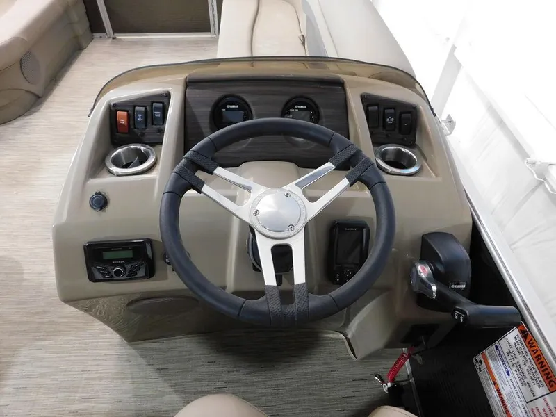Slide: The Image of 2023 Bennington 20SSSP boat dashboard with steering wheel and controls. - 16