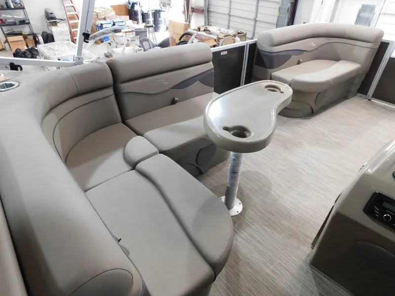 Slide: The Image of 2023 Bennington 20SSSP pontoon boat interior with plush seating and table. - 17