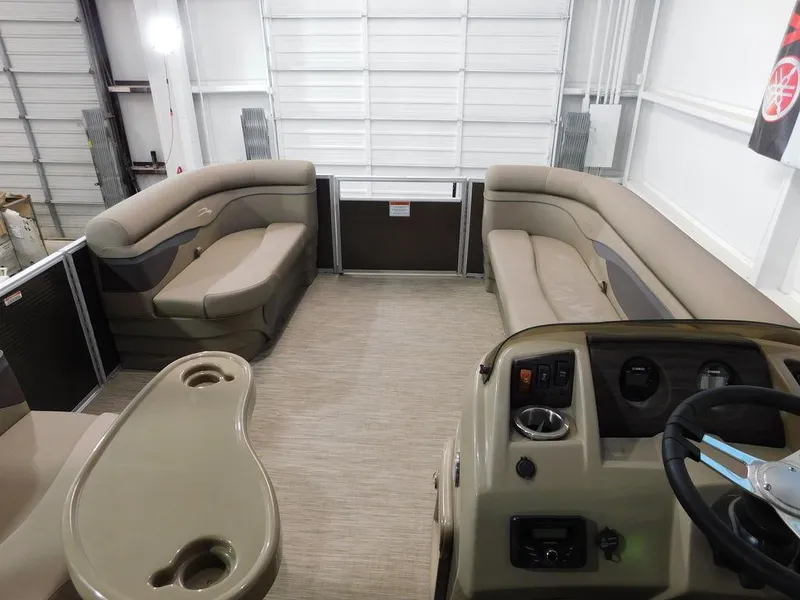 Slide: The Image of 2023 Bennington 20SSSP pontoon boat interior with beige seating and helm. - 18