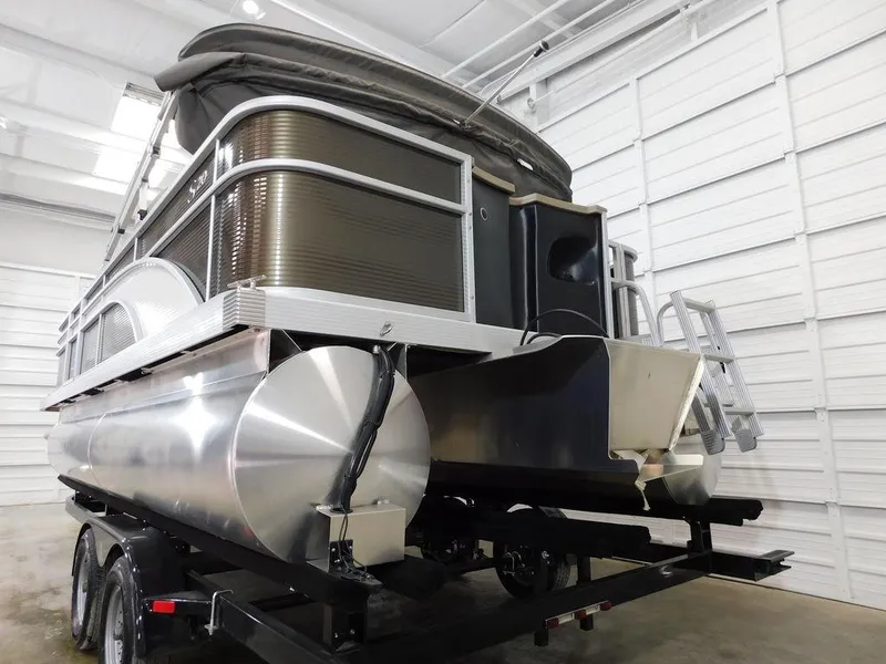 Slide: The Image of 2023 Bennington 20SSSP pontoon boat in a showroom, rear view. - 3