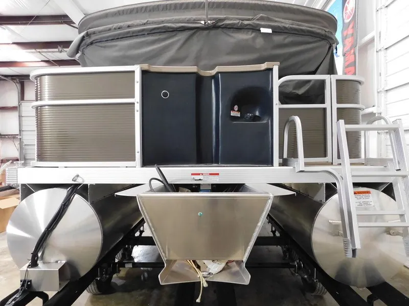 Slide: The Image of 2023 Bennington 20SSSP pontoon boat in a storage facility. - 5