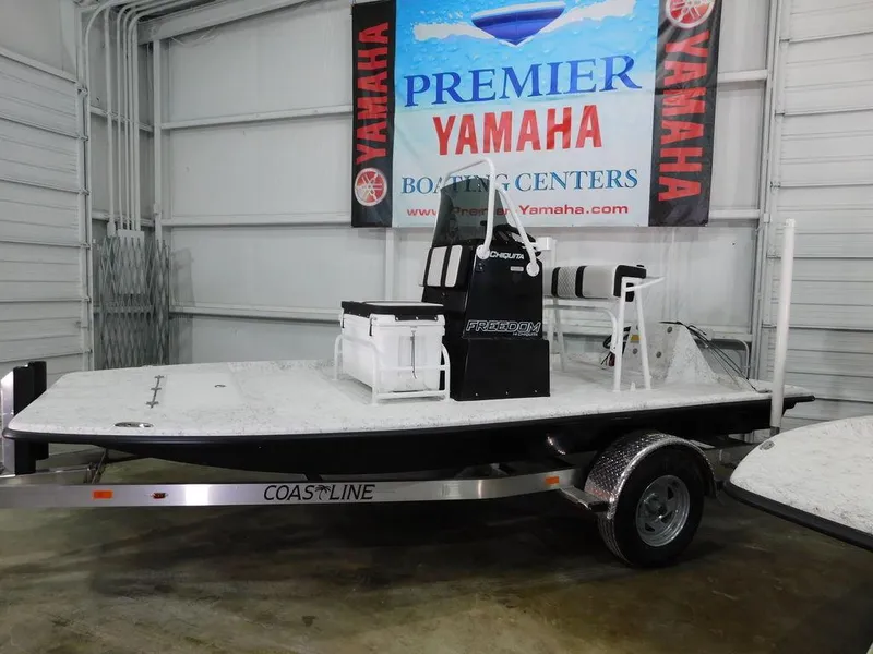 Slide: The Image of 2024 Freedom 14 Chiquita boat on trailer at Premier Yamaha Boating Center. - 1