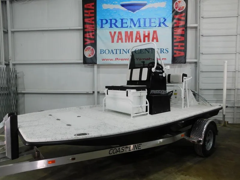 Slide: The Image of 2024 Freedom 14 Chiquita boat on trailer at Yamaha dealership. - 11