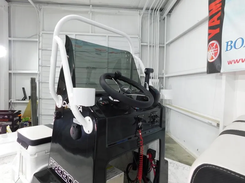 Slide: The Image of 2024 Freedom 14 Chiquita boat console in a garage setting. - 12