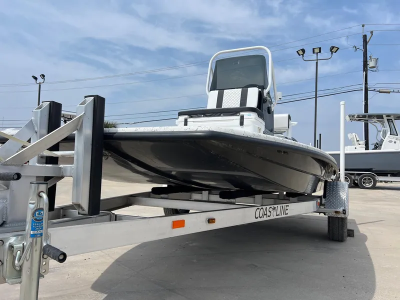 Slide: The Image of 2024 Freedom 14 CHIQUITA boat on trailer, outdoor display, clear sky background. - 15