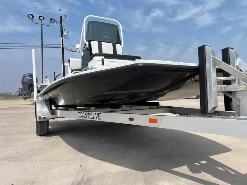 Slide: The Image of 2024 Freedom 14 CHIQUITA boat on trailer under clear sky. - 17