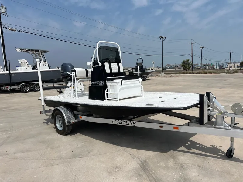 Slide: The Image of 2024 Freedom 14 CHIQUITA boat on trailer in parking lot under clear sky. - 18