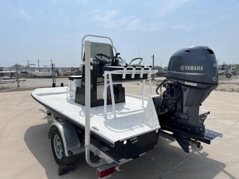 Slide: The Image of 2024 Freedom 14 Chiquita boat with Yamaha motor on trailer in outdoor setting. - 23