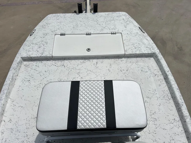 Slide: The Image of 2024 Freedom 14 CHIQUITA boat deck with cushioned seat and storage compartment. - 24