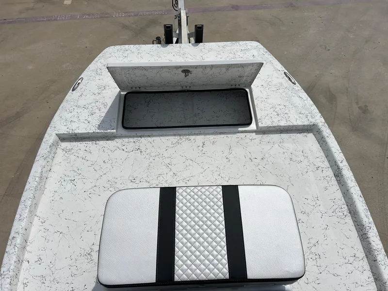 Slide: The Image of 2024 Freedom 14 CHIQUITA boat deck with storage compartment and cushioned seat. - 25