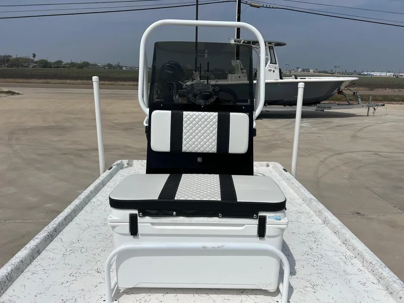 Slide: The Image of 2024 Freedom 14 CHIQUITA boat with cushioned seating and steering console on a trailer. - 27