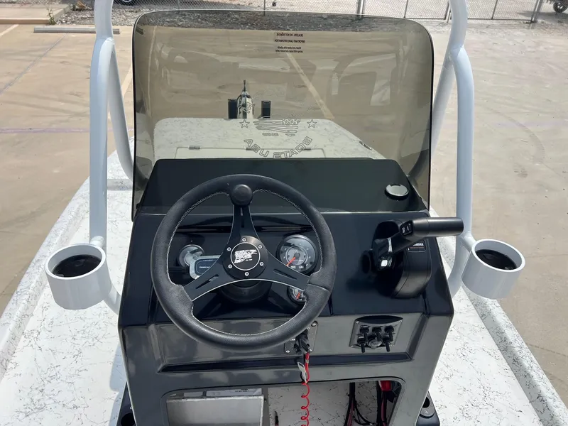 Slide: The Image of Steering console of 2024 Freedom 14 CHIQUITA boat with cup holders and controls. - 30