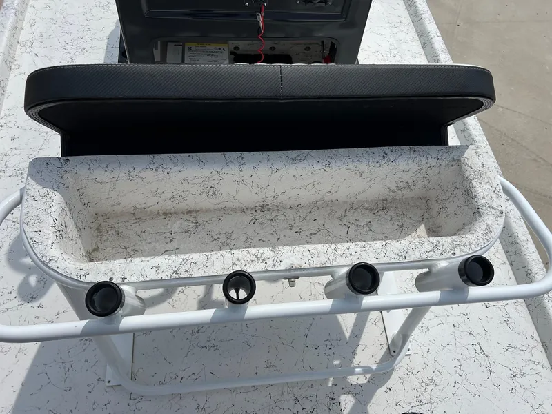 Slide: The Image of Open storage compartment on 2024 Freedom 14 CHIQUITA boat with rod holders. - 32