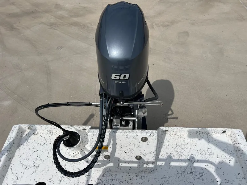 Slide: The Image of Outboard motor on a 2024 Freedom 14 CHIQUITA boat, featuring a Yamaha 60 engine. - 33