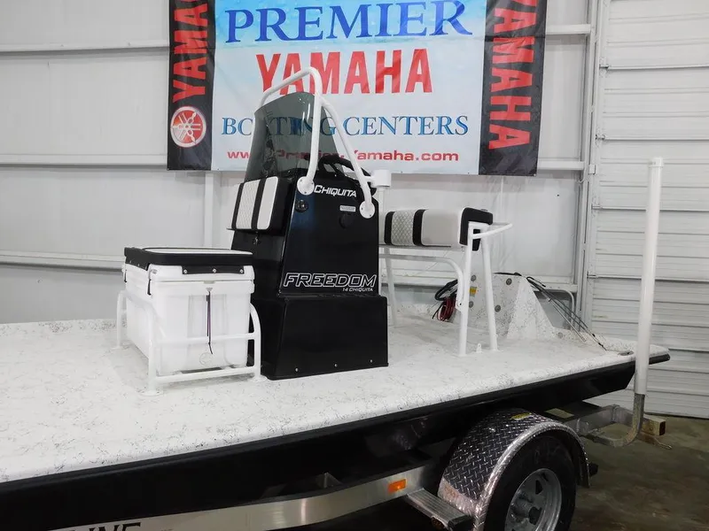 Slide: The Image of 2024 Freedom 14 Chiquita boat at Yamaha Boating Center showroom. - 6