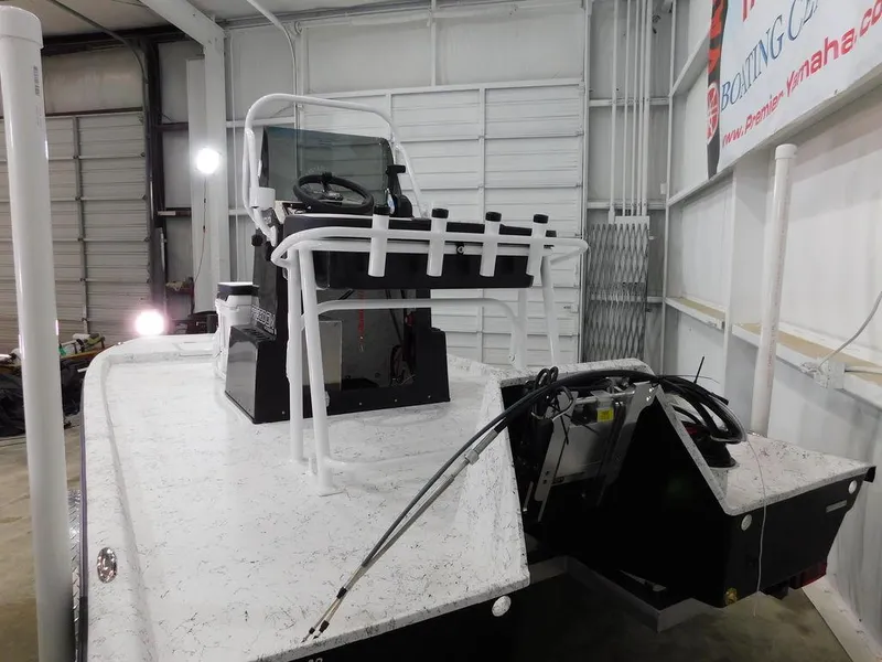 Slide: The Image of 2024 Freedom 14 CHIQUITA boat in a garage, featuring a white and black design. - 7