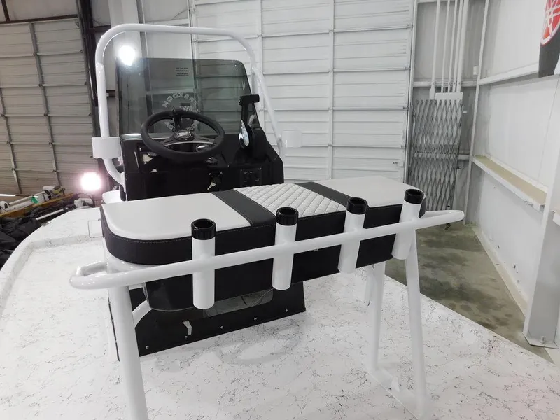 Slide: The Image of 2024 Freedom 14 CHIQUITA boat interior with steering console and rod holders. - 8