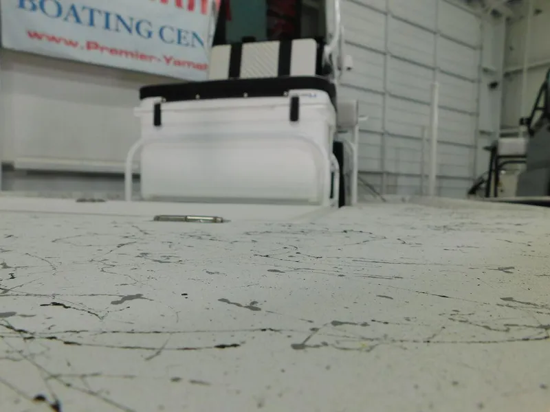 Slide: The Image of 2024 Freedom 14 CHIQUITA boat interior with textured flooring in a showroom. - 9