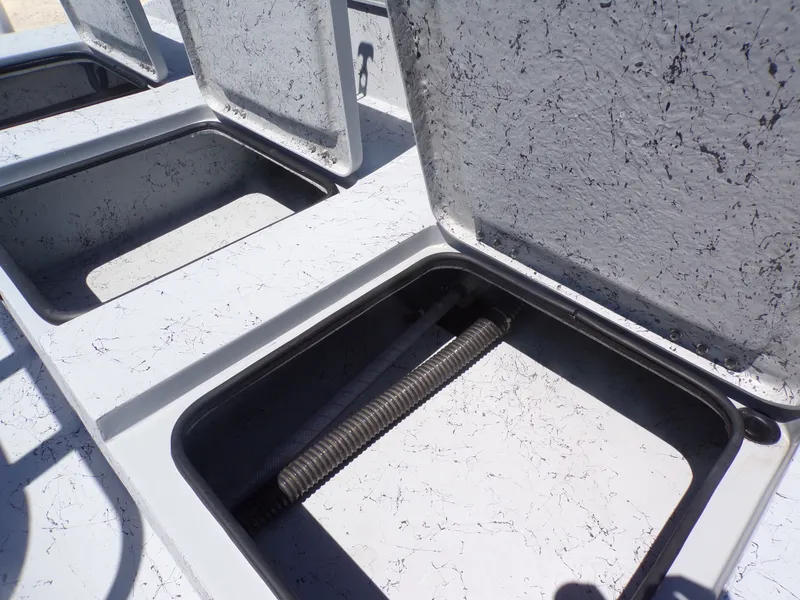 Slide: The Image of Open storage compartments on a 2025 Freedom Eagle 16 boat. - 25