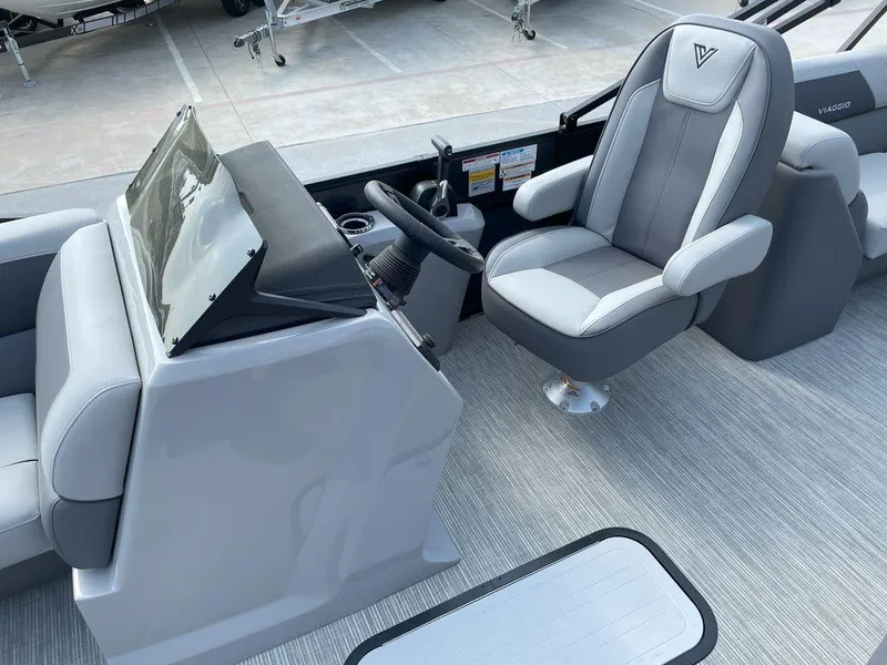Slide: The Image of 2024 Viaggio V22U boat interior with sleek captain's chair and modern dashboard. - 13