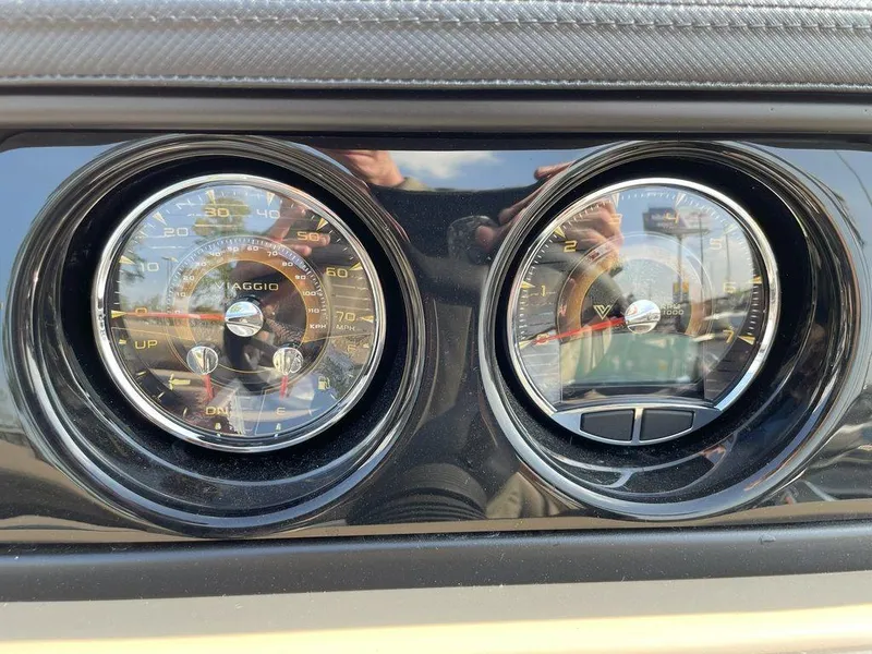 Slide: The Image of 2024 Viaggio Z22S dashboard with dual analog gauges, speedometer, and tachometer. - 12