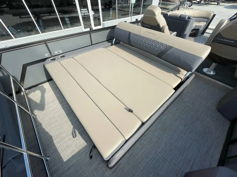 Slide: The Image of 2024 Viaggio Z22S boat interior with beige convertible seating and cup holders. - 14