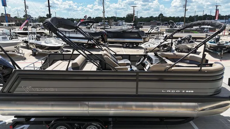 Slide: The Image of 2024 Viaggio Z22S pontoon boat displayed at a marina under a sunny sky. - 17