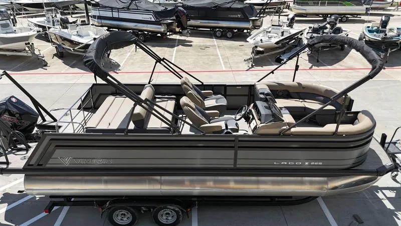 Slide: The Image of 2024 Viaggio Z22S pontoon boat in a marina, showcasing sleek design and spacious seating. - 18