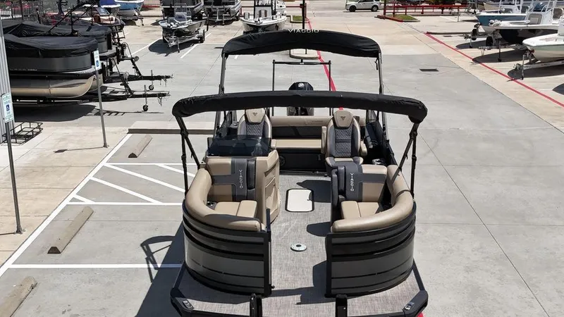 Slide: The Image of 2024 Viaggio Z22S pontoon boat in a marina parking lot. - 22