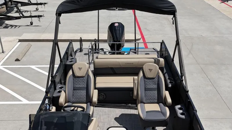 Slide: The Image of 2024 Viaggio Z22S pontoon boat with stylish seating and canopy in a parking lot. - 23