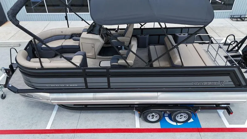 Slide: The Image of 2024 Viaggio Z22S pontoon boat with canopy, parked on trailer. - 29
