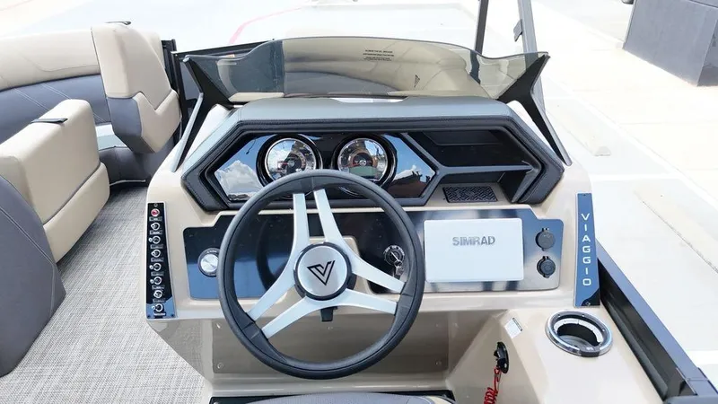 Slide: The Image of 2024 Viaggio Z22S boat dashboard with steering wheel and control panel. - 38